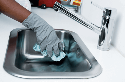 Cleaning sink in kitchen